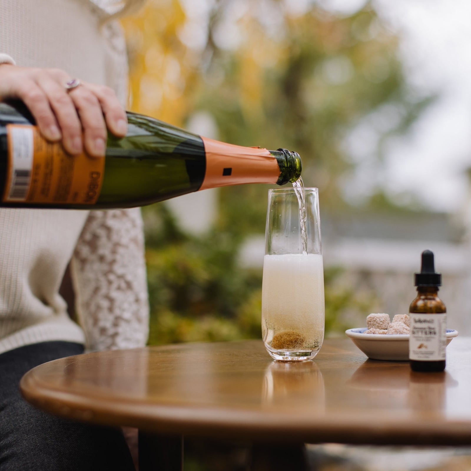 image of champagne being poured into a glass over a sugar cube